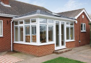 White uPVC Edwardian conservatory with a tiled roof