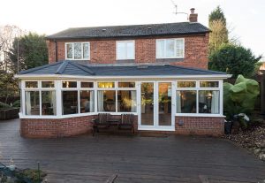 White uPVC P shaped conservatory with a tiled roof