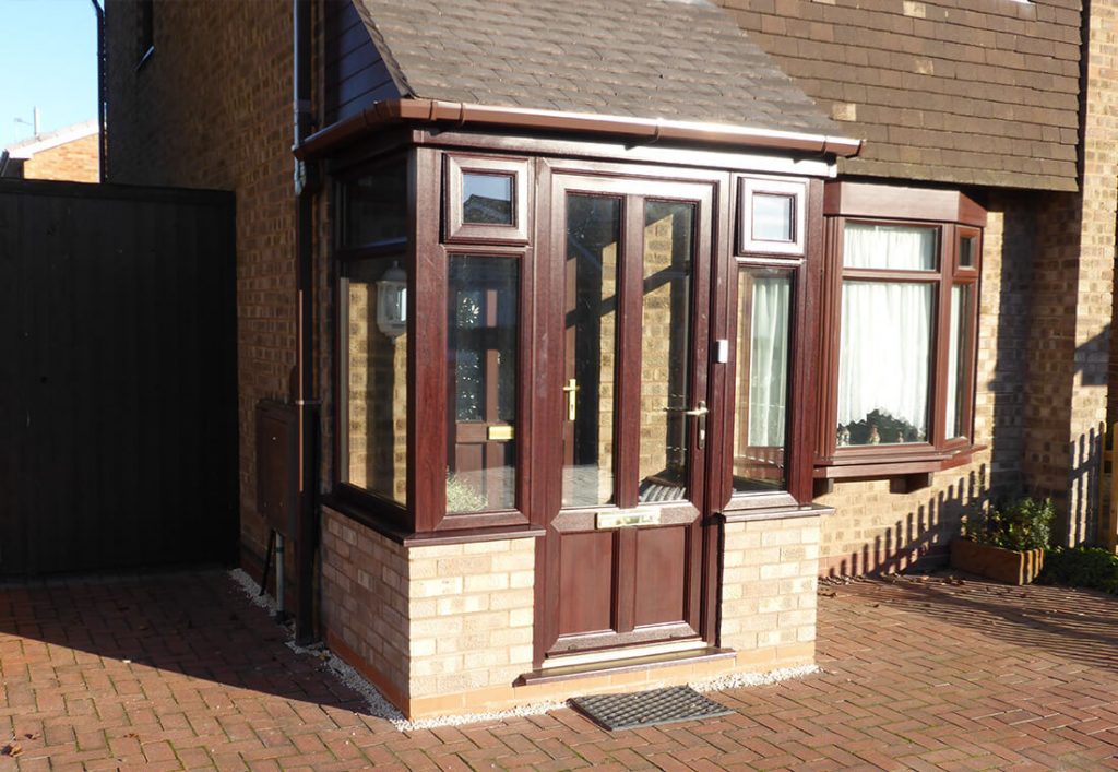 Rosewood uPVC front door and porch with a tiled roof