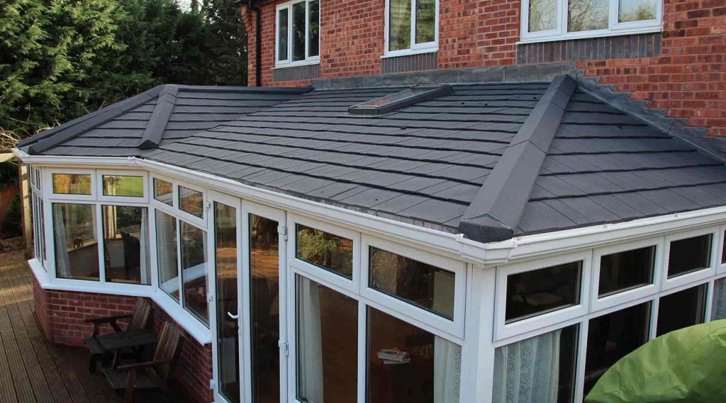 P-Shaped conservatory with a grey tiled roof